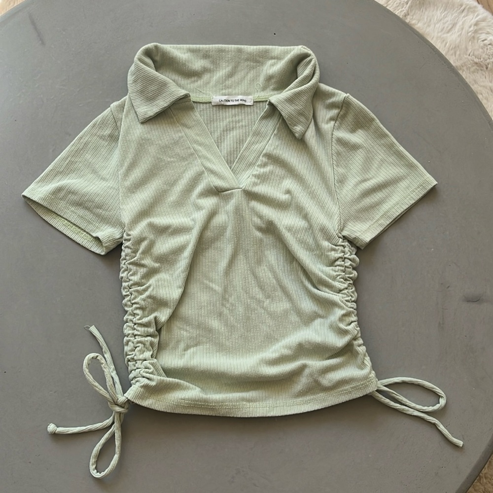 Caution to the wind slightly cropped polo shirt with drawstrings